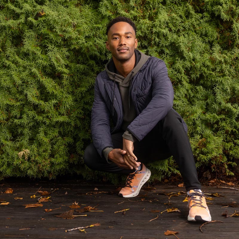 Man crouching wearing athletic outfit